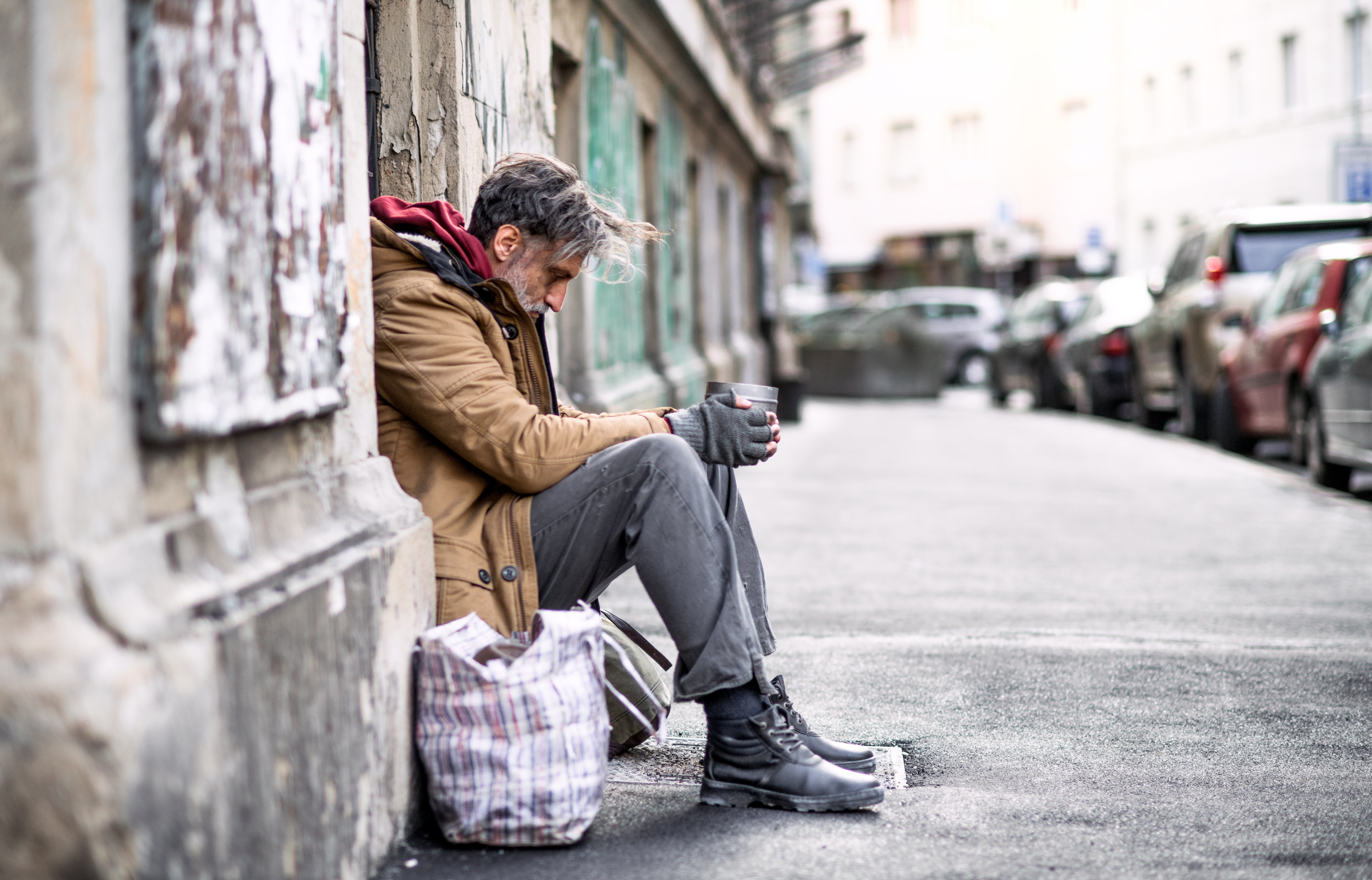 Težnja globalni Procjenjuje se  Homeless beggar man sitting outdoors in city asking for money donation. -  Foundation Housing